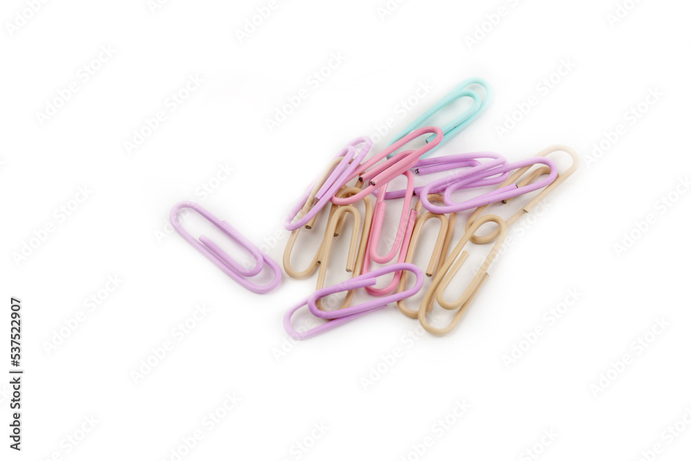 Multicolored paper clips close up isolated on white background. Stationery concept. Multicolored paper clips close up isolated on white background. Stationery concept.