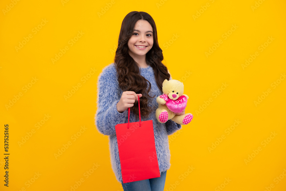 Teenager hold shopping bag enjoying sale. Child girl is ready to go shopping. Happy teenager, positive and smiling emotions of teen girl. Teenager hold shopping bag enjoying sale. Child girl is ready to go shopping. Happy teenager, positive and smiling emotions of teen girl.