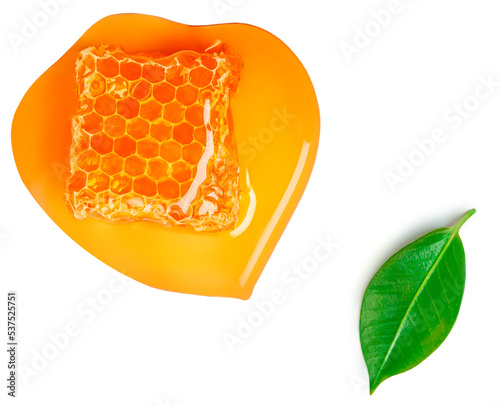 Honeycomb with flowing honey syrup isolated on white background. Honey, green leaves Flat lay. Food concept..