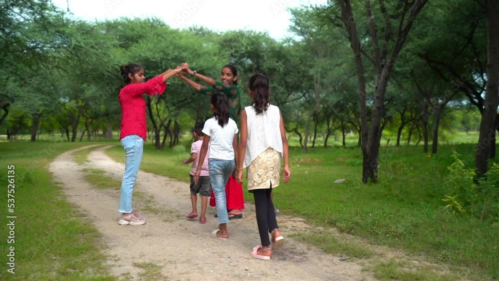 Asian student playing local game at garden. This concept can use for eduction, kid, student, work and teacher concept. Asian student playing local game at garden. This concept can use for eduction, kid, student, work and teacher concept.