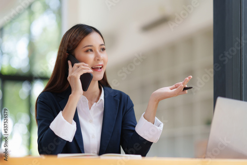 Wallpaper Mural Asian Business woman making business call talking on phone. Account and Finance concept Torontodigital.ca
