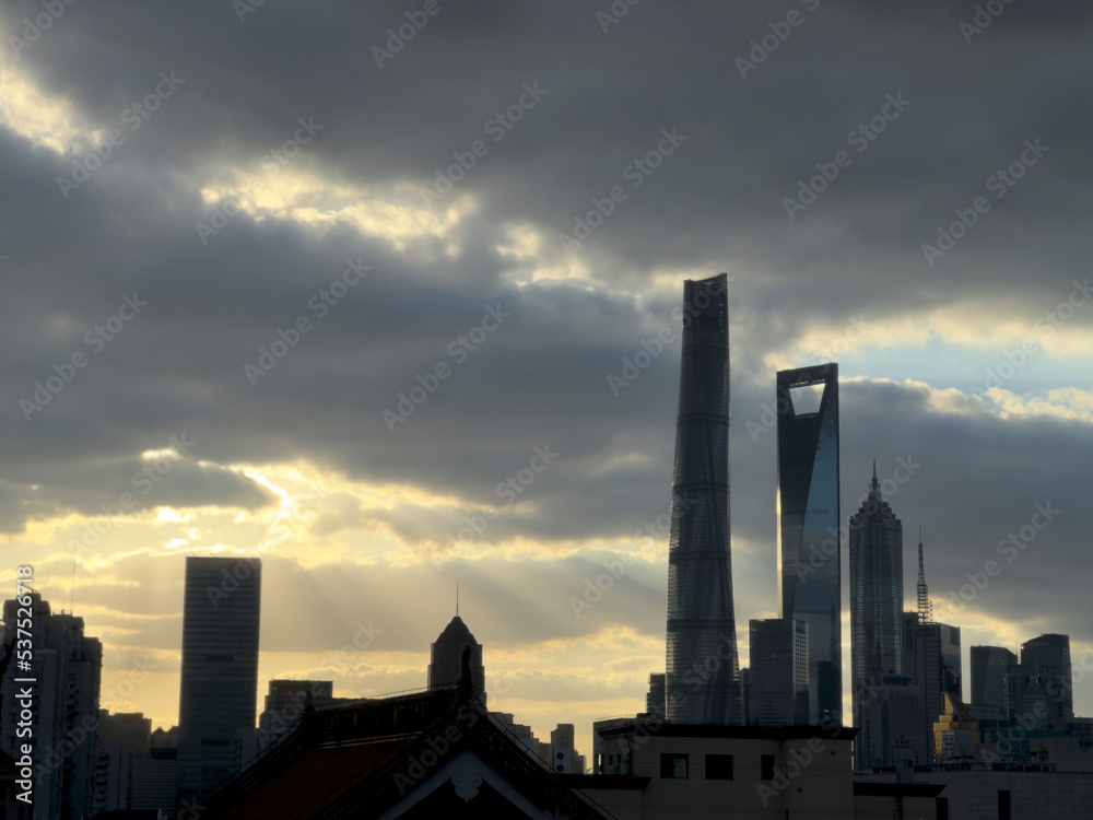 modern landmarks in Lujiazui, Pudong,Shanghai city with sunset Tyndall effect sunlight cloudy sky