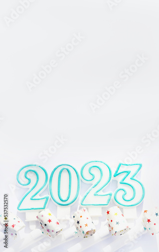 Festive pipes and numbers 2023 from candles on a white background. New Year, postcard or cover