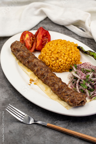 Adana kebab on dark background. Traditional Turkish kebab delicacies. close up