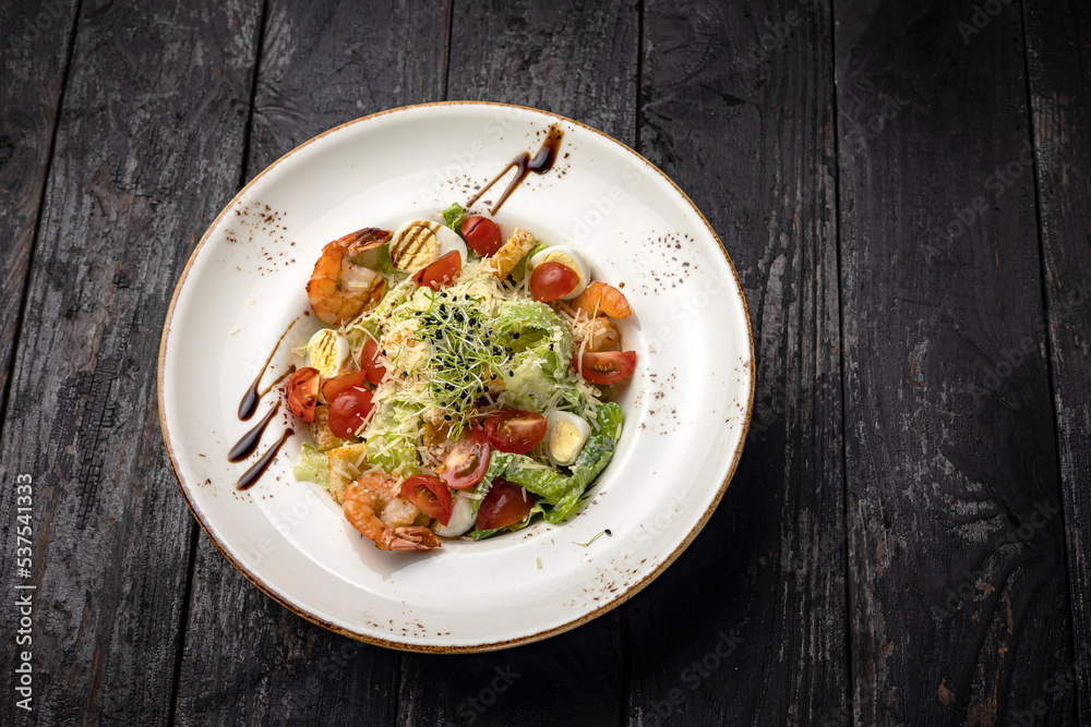 delicious salad in a plate on a dark table
delicious salad in a plate on a dark table