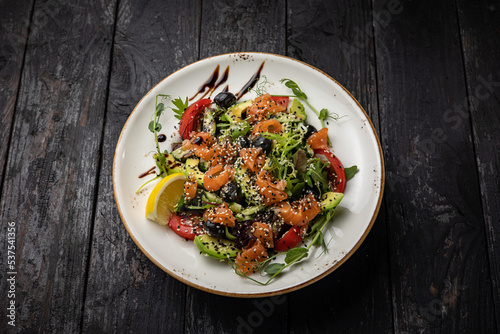 delicious salad in a plate on a dark table 