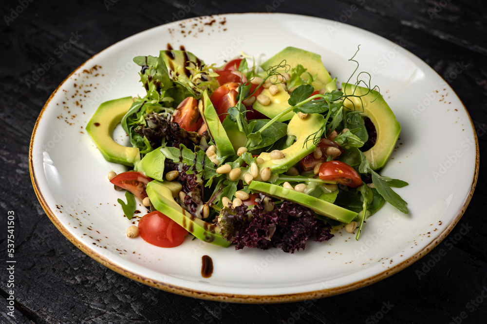 delicious salad in a plate on a dark table
delicious salad in a plate on a dark table