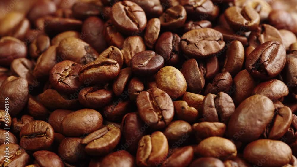Roasting coffee beans with smoke on dark background, close up arabica robusta colombian beans. Roasting coffee beans with smoke on dark background, close up arabica robusta colombian beans.