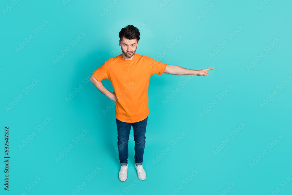 Full size photo top angle view of rage guy ask employees go away point empty space isolated on cyan color background Full size photo top angle view of rage guy ask employees go away point empty space isolated on cyan color background