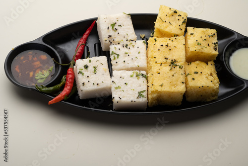 Indian popular Gujrati breakfast dish White Dhokla, Khatta , Rice and Urad Dal Khaman. Also known as Instant Rava Dhokla AND yellow dhokla or besan gram flour. served with ketchup  photo