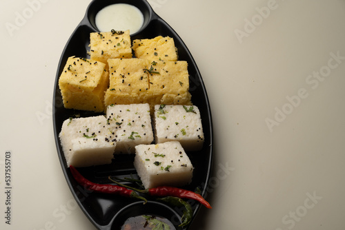 Indian popular Gujrati breakfast dish White Dhokla, Khatta , Rice and Urad Dal Khaman. Also known as Instant Rava Dhokla AND yellow dhokla or besan gram flour. served with ketchup  photo