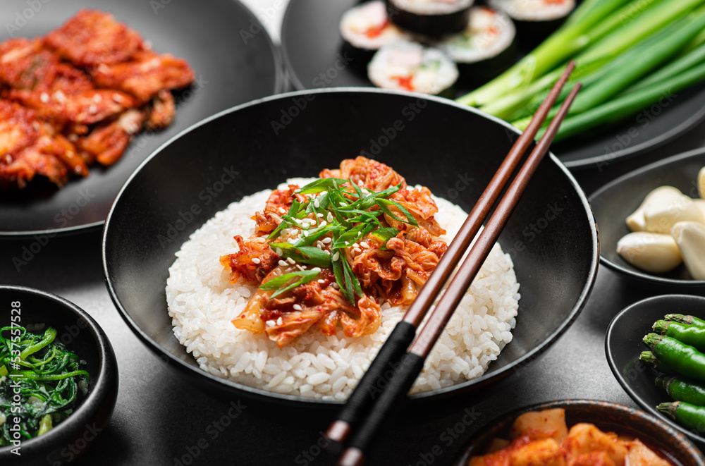 Korean food, rice, kimchi, kimbap, pickled radish on black background Korean food, rice, kimchi, kimbap, pickled radish on black background