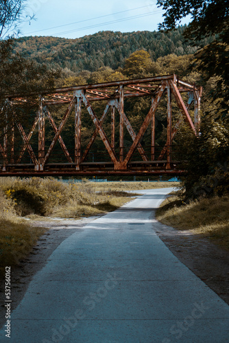 old metal bridge over the road in the mountains