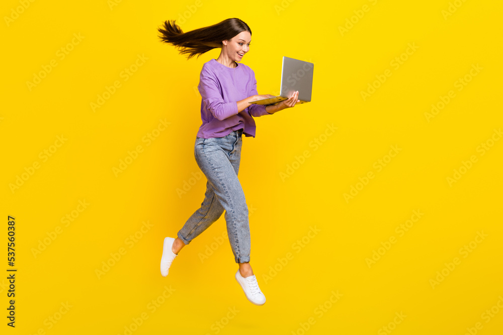 Full length photo of positive pretty lady use modern device hurry meeting conference go empty space isolated on yellow color background