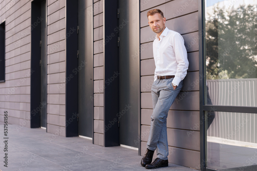 attractive man in office clothes near the business center attractive man in office clothes near the business center