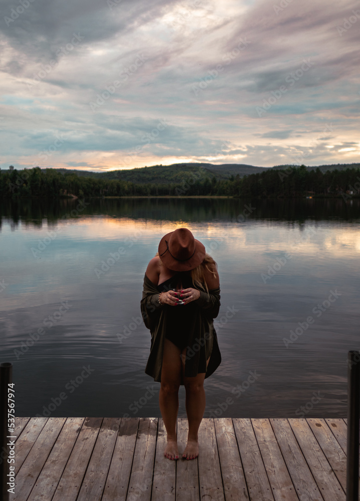 Lake with wooden platform and woman posing
