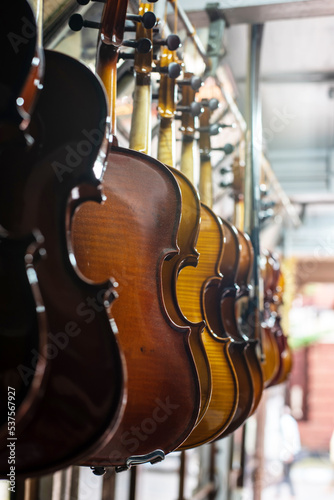 Violins are hanging in retail store to sell