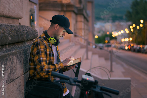 Young man with illuminated tablet on the street at night © Cristian Blázquez