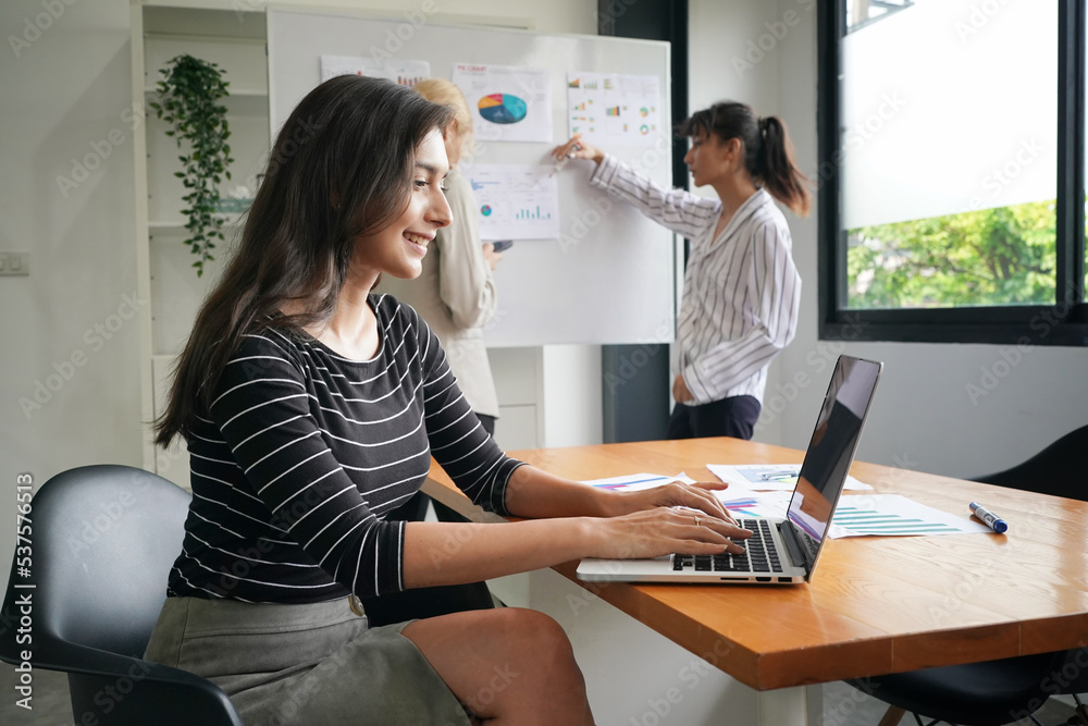 Profile side photo of smart cool Asian girl entrepreneur sit table use laptop work presentation in office loft workplace Profile side photo of smart cool Asian girl entrepreneur sit table use laptop work presentation in office loft workplace