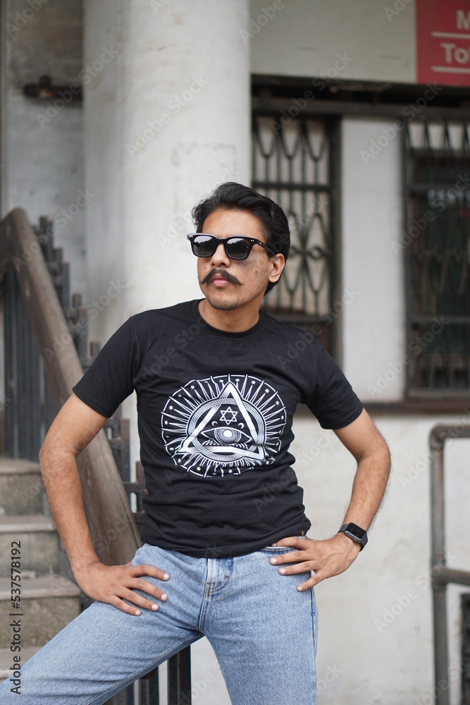 guy wearing black clothes infront of old building guy wearing black clothes infront of old building