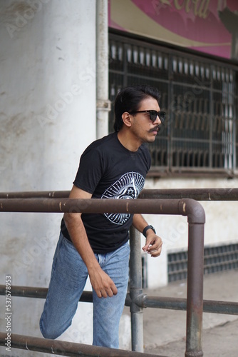 man posing infront of a old building