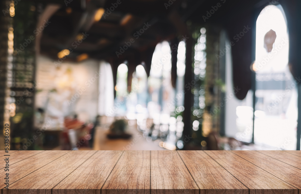 Empty wooden table top with lights bokeh on blur restaurant background. Empty wooden table top with lights bokeh on blur restaurant background.
