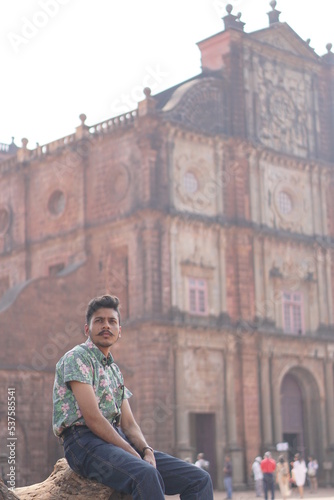 man posing infront of old goa chruch