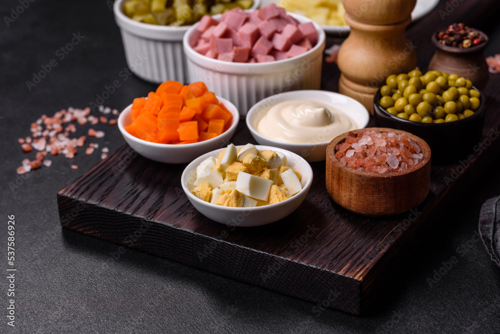 Delicious fresh Olivier salad with sausage, egg, cucumber, green peas, carrots and mayonnaise Delicious fresh Olivier salad with sausage, egg, cucumber, green peas, carrots and mayonnaise