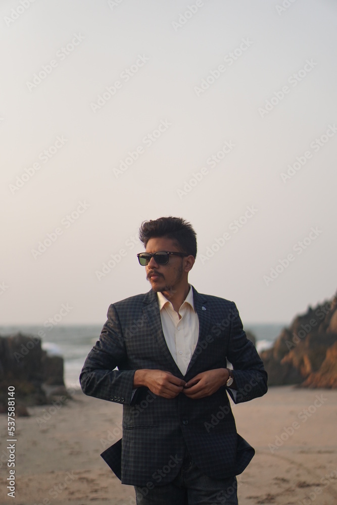 man wearing sui posing near beach man wearing sui posing near beach