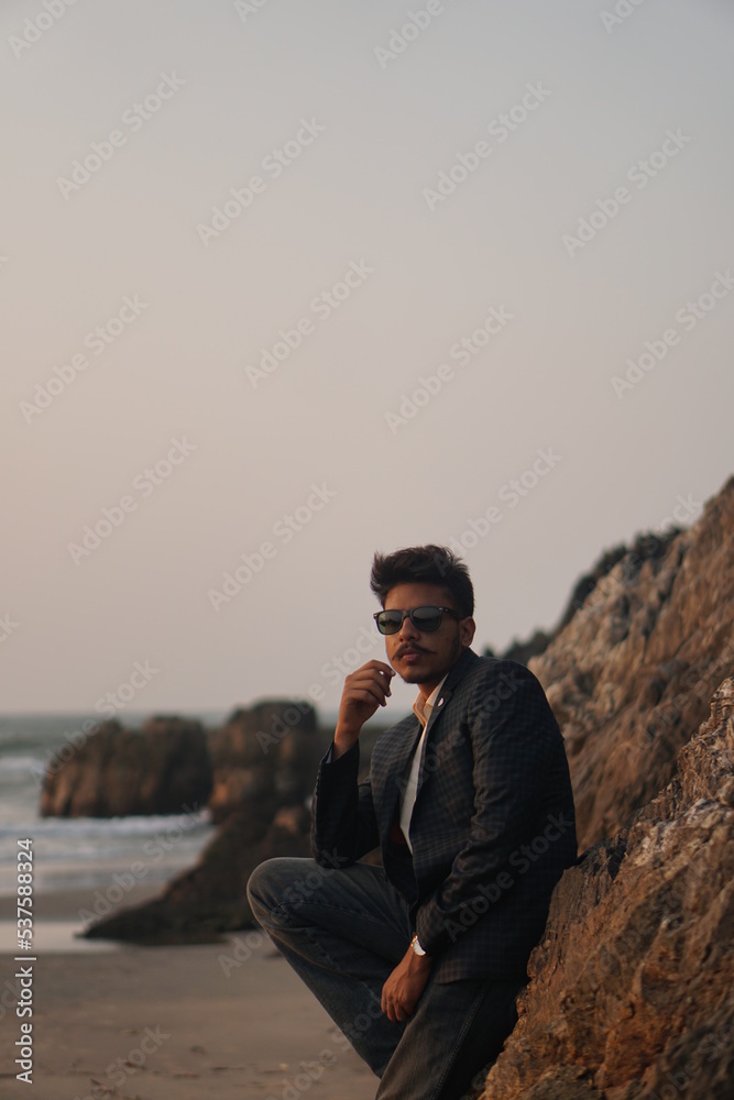 man wearing sui posing near beach man wearing sui posing near beach
