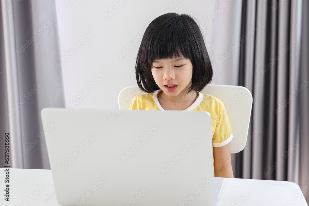 little asian girl student study online using laptop computer at home little asian girl student study online using laptop computer at home