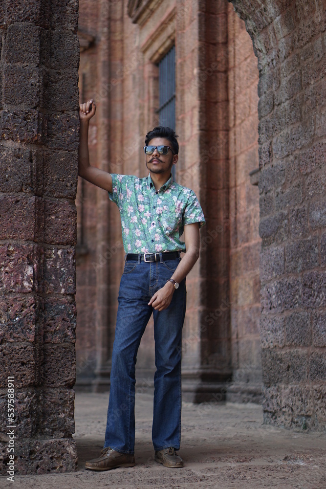man wearing green shirt posing infront of old chruch man wearing green shirt posing infront of old chruch