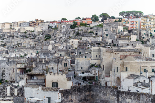 old stone houses and churches on the ravine slopes in the historic center of the old town of Matera. Narrow cobbled streets and cascading buildings with rocks and tightly built-up streets © Piotr