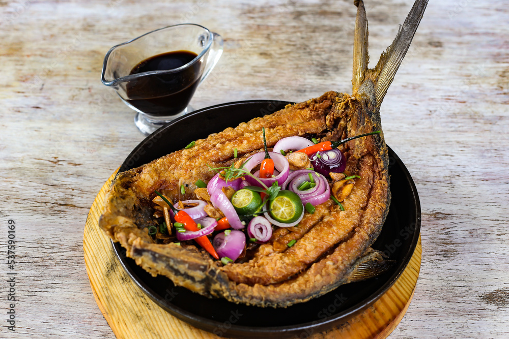 Sizzling Giant Bangus A La Pobre with soya sauce served in a dish ...