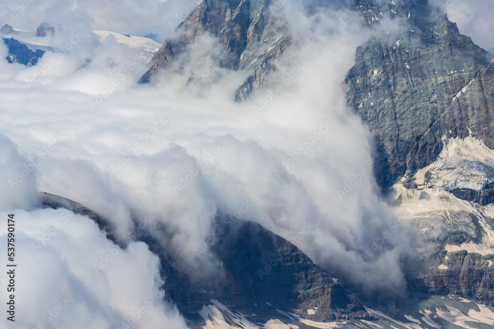 Beautiful alpine scenery in the Swiss Alps in winter, with dramatic cloudscape