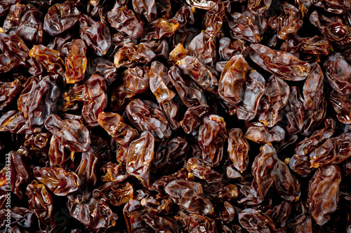Close-up shot of freshly dried dark-colored raisins.