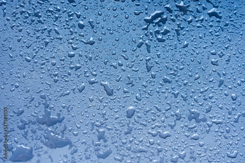 Damp blue surface with drops of water.