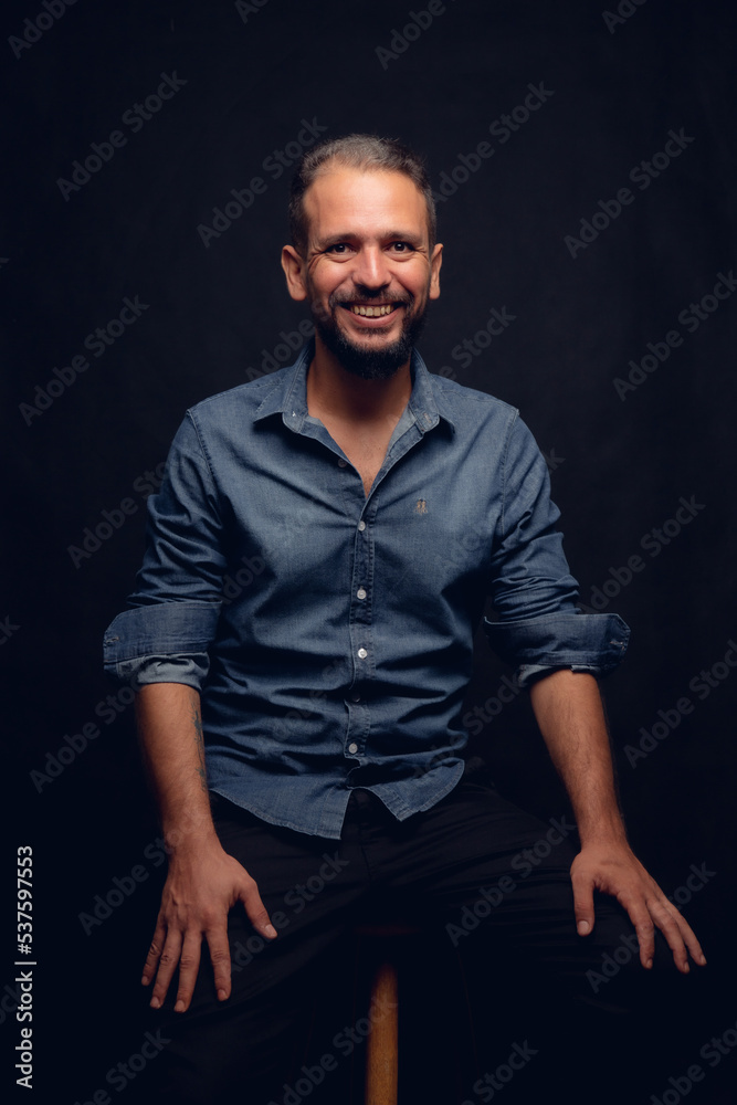 White man smiling, in studio, gray hair