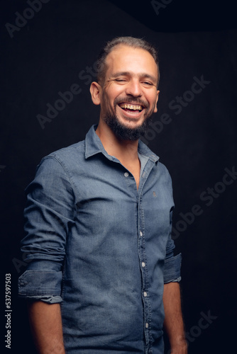 White man smiling, in studio, gray hair