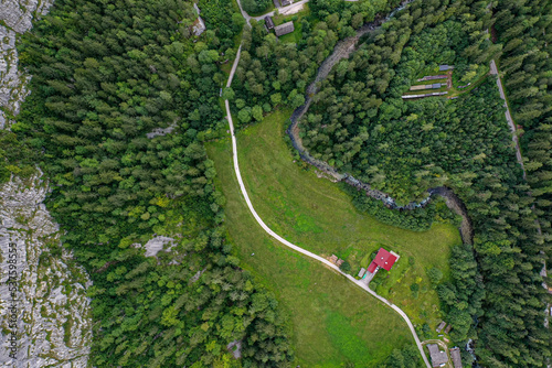 Top-down view of forest house and small river