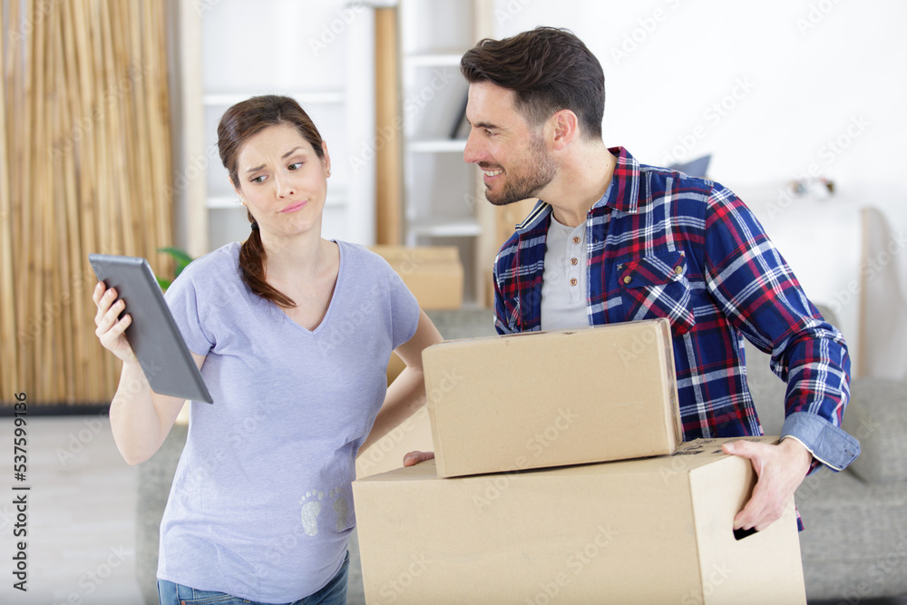 pregnant woman shows tablet to man pregnant woman shows tablet to man