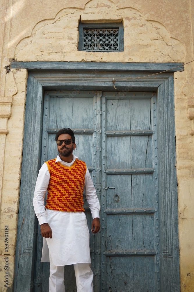 boy wearing old clothes infront of vintage building