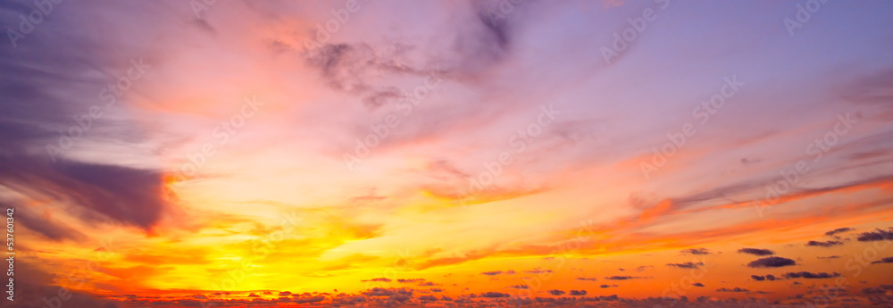 Beautiful sky with bright sunset (sunrise) and clouds. Wide photo.