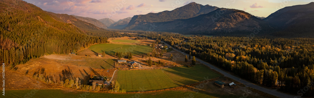 Aerial Panoramic View of the Historic Methow Valley in Eastern Washington State. Farm and ranch land lead to the North Cascade Mountains in this stunning landscape photographed on an autumnal morning.