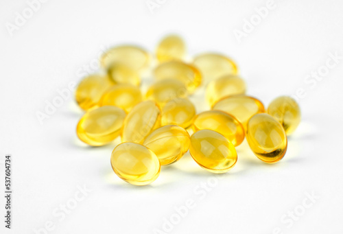 Yellow capsules close-up. Capsules with fish oil or vitamin 3d, selective focus
