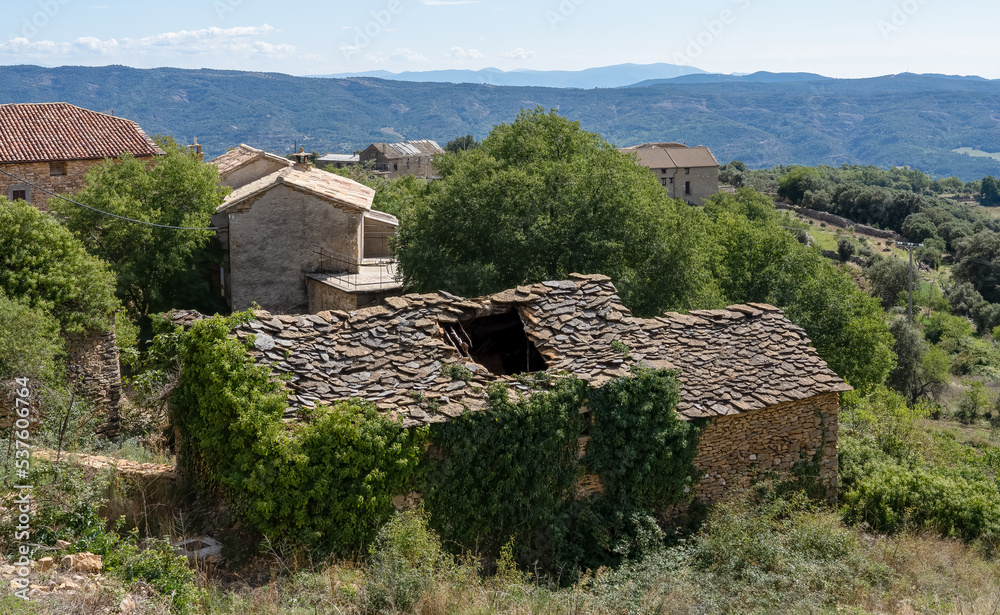 an old Spanish farm cottage with stone walls and stone roof tiles