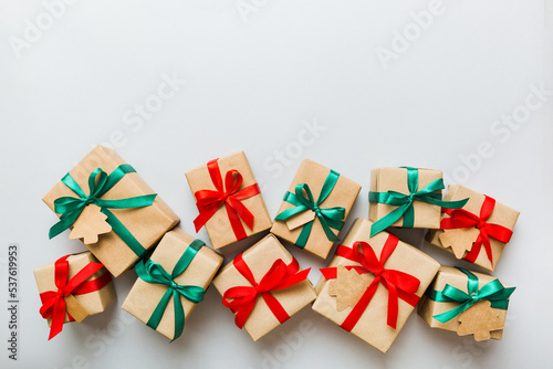 Fotografie wrapped christmas or other holiday handmade present in paper with colored ribbon