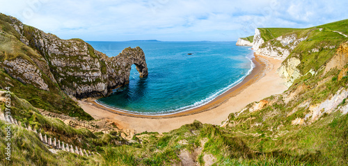 Durdle Door on the Jurrassic Coast in Dorset, England, UK; seascape natural landscape with rocks and while cliffs on the beach