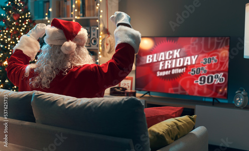 Santa watching a Black Friday TV commercial
