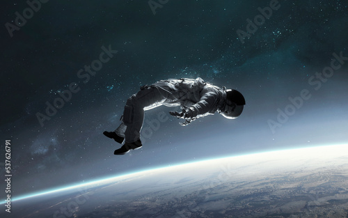 Foto 3D illustration of astronaut falling to earth planet